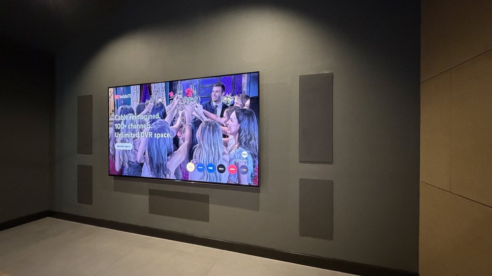 A wall-mounted television with carefully positioned hardware and concealed cables.