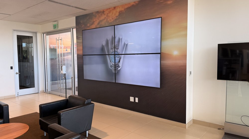 Multiple screens in a commercial lounge, arranged for viewing throughout the space.